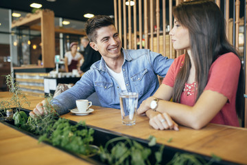 Happy young couple in restaurant