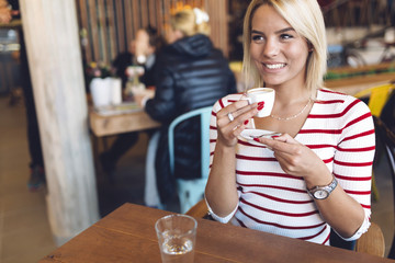Beautiful woman drinking coffee in cafe