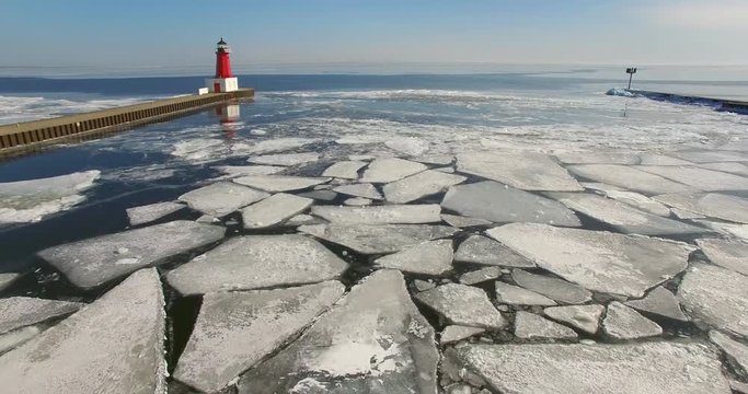 Icy winter flyby of Menominee North Pier Lighthouse. This lighthouse marks the mouth of the Menominee River running between Marinette Wisconsin and Menominee Michigan.