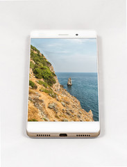 Modern smartphone displaying picture of beautiful natural coastl