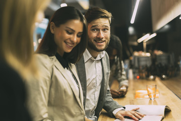 Friends at the counter of a bar after work