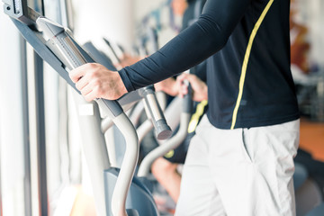 Young healthy group of people working out on a elliptic trainer