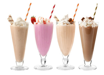 Glasses with delicious milk shakes on white background.