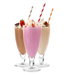 Glasses with delicious milk shakes on white background.