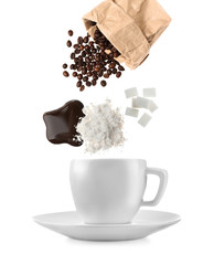 Ingredients for delicious coffee with cup on white background