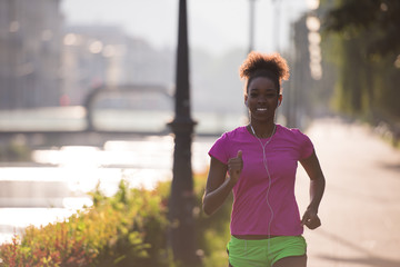 african american woman jogging in the city