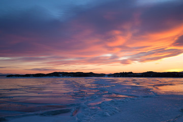 Winter landscape with color ice, sunset