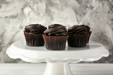 Tasty cupcakes on stand