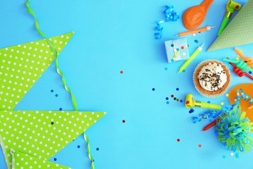 Birthday party objects on blue background, top view