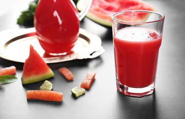 Watermelon smoothie with mint and lime slices on table