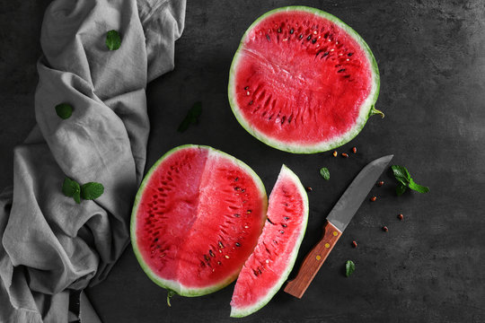 Watermelon slices with knife on table