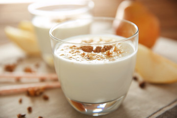 Tasty milk shake with walnut on table
