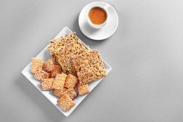 Cereal cookies with cup of coffee on color background