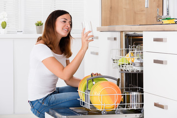 Woman Taking Drinking Glass From Dishwasher