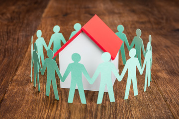 House Model With Papercut On Wooden Desk