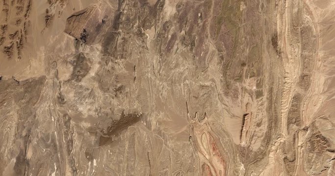 High-altitude overflight aerial of rocky desert in the  Yazd and Khorasan provinces of Iran. Clip loops and is reversible. Elements of this image furnished by USGS/NASA Landsat 