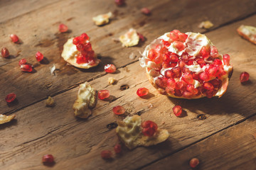 Falling down ripe pomegranate with cracks and splashes of juice