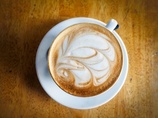 Flat White, a cup of coffee on wooden background