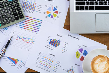 Office desk working table with  pen, laptop computer, business graph or analysis chart and,...