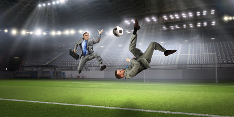 Fototapeta na wymiar Businessman playing soccer . Mixed media
