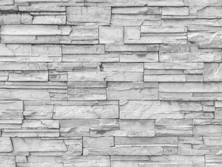 Closeup surface brick pattern at old stone brick wall textured background in black and white tone