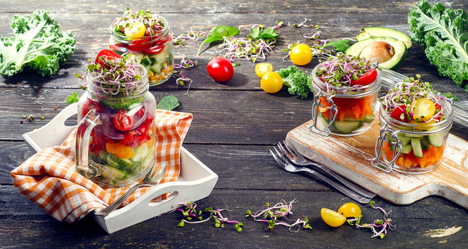 Fresh vegetable Salad in jars.  Diet  eating concept.