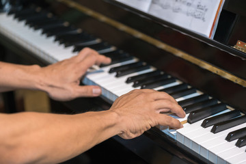 Fototapeta na wymiar Hands playing the piano (close-up) 