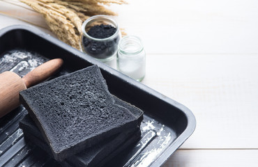 Charcoal bread,Black bread with rolling pin on wood