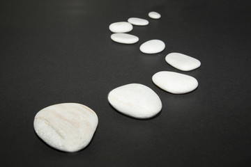 The way from boulder stones on the black background