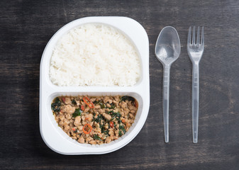 Rice topped with stir fried minced pork and basil on wood,top vi