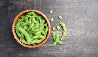 Green Japanese Soybean in wooden bowl on table wood,top view