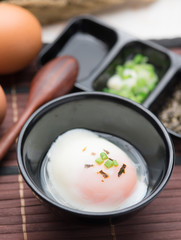 Soft boiled egg or onsen egg on wooden