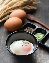 Soft boiled egg or onsen egg on wooden