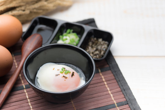 Soft boiled egg or onsen egg on wooden