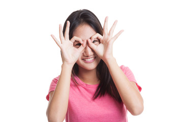 Asian woman do funny  double OK sign as glasses