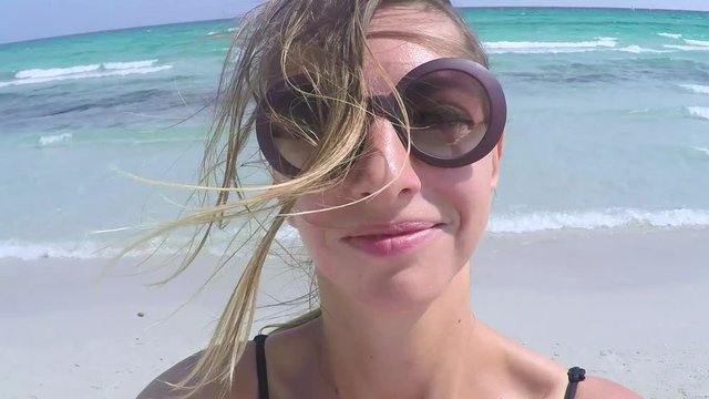 Young woman takind a selfie with gopro camera