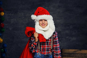 Fototapeta na wymiar Teenage boy dressed in Santa's holiday costume.