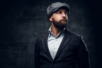 A man in woolen jacket and tweed cap.