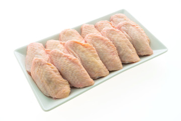 Raw chicken meat and wing in white plate