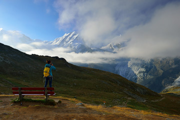 Fototapeta premium The woman hiker are looking from Rotenboden station to mountain