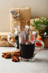 Cup with mulled wine and gift boxes
