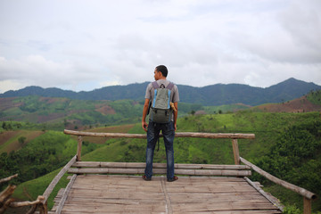 Man standing on the point of view of the mountains at Nan, Thailand