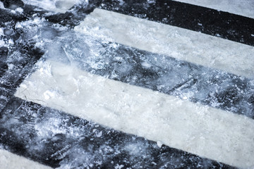 Crosswalk with Snow icy on asphalt road,Dangerous and High risk