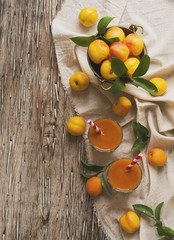 Fresh apricot juice in glass on wooden table, selective focus
