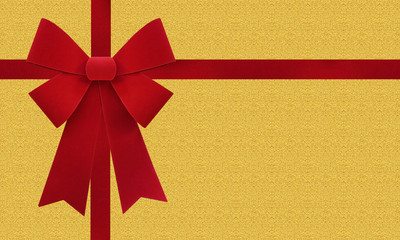 Large red Christmas bow isolate on gold paper background