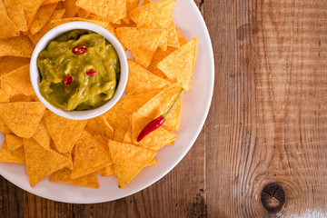 Guacamole dip and nacho chips.
