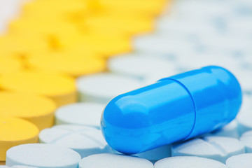 blue medical pill on background of colored medical pills