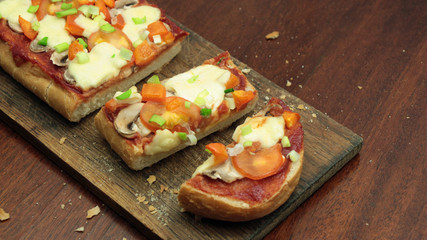 Fototapeta na wymiar Bread Pizza Sprinkled with Spring Onion on White Plate