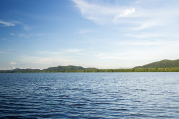 Fototapeta premium Landscape view with deep blue sky. Light from the right. Contrast on water wave.