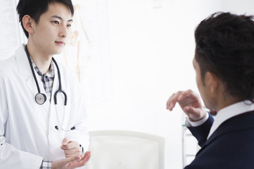 Businessman and doctor are talking in the examination room